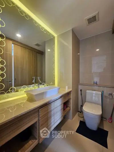Modern bathroom with illuminated mirror and sleek fixtures