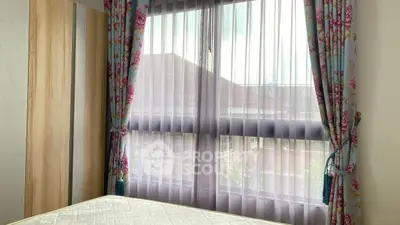 Cozy bedroom with floral curtains and natural light