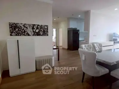 Spacious modern living area with elegant dining set and open kitchen layout.