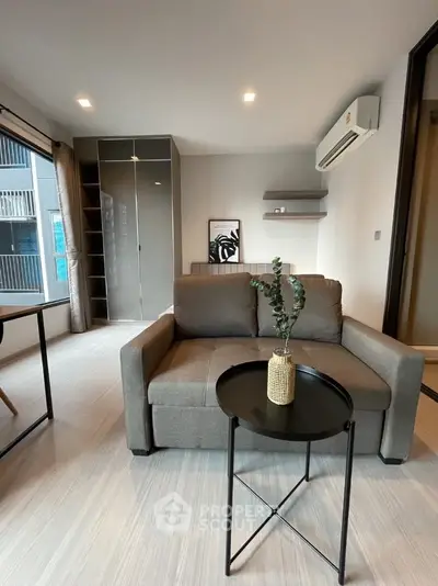 Modern living room with sleek furniture and air conditioning in a stylish apartment.