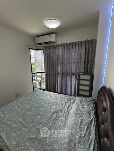 Cozy bedroom with natural light and modern air conditioning unit.