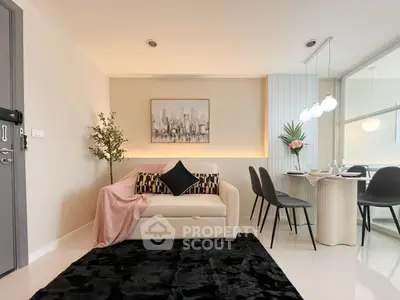 Stylish modern living room with chic decor and dining area, perfect for urban living.