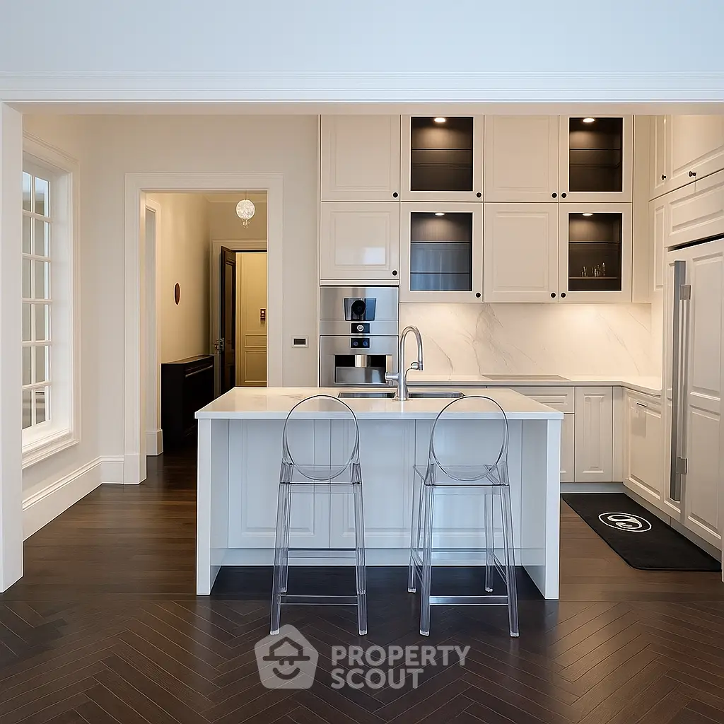 Luxurious modern kitchen with island, sleek cabinetry, and elegant lighting in a high-end home.