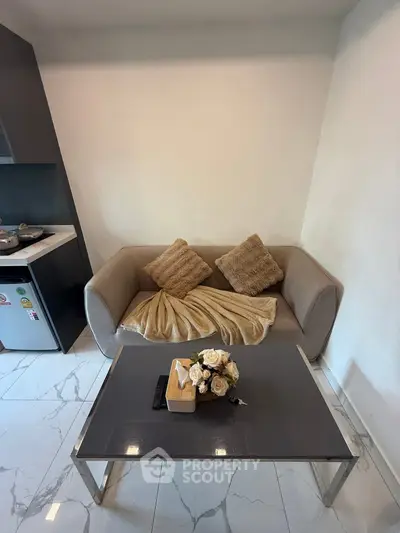 Cozy living room with modern sofa and elegant coffee table in a stylish apartment.