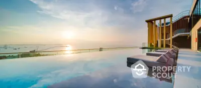 Luxurious rooftop infinity pool with stunning ocean view at sunset