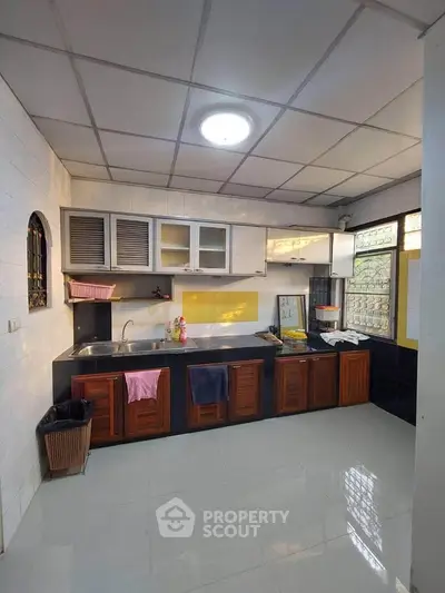 Spacious kitchen with modern cabinets and ample counter space.