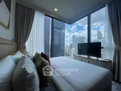 Luxurious bedroom with stunning city view in modern high-rise apartment