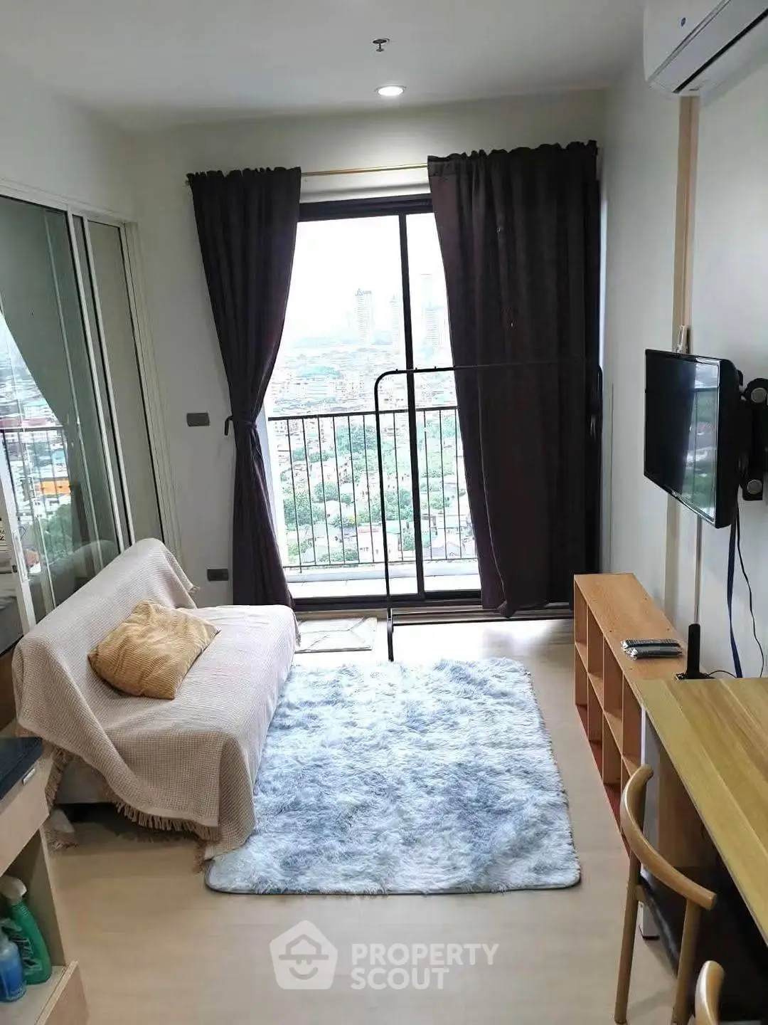 Cozy living room with balcony view in modern apartment