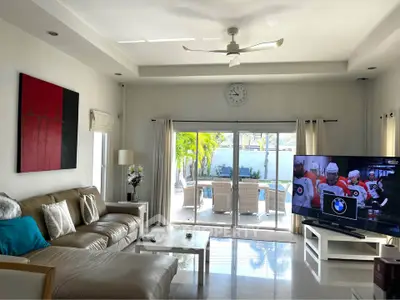 Spacious living room with modern decor and sliding doors to patio