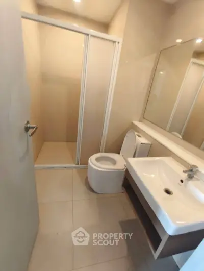 Modern bathroom with sleek fixtures and spacious shower area