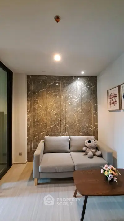 Stylish living room with modern sofa and elegant marble accent wall