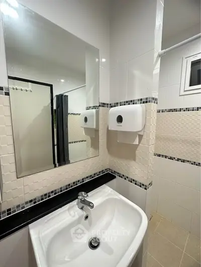 Modern bathroom with sleek sink and stylish wall tiles