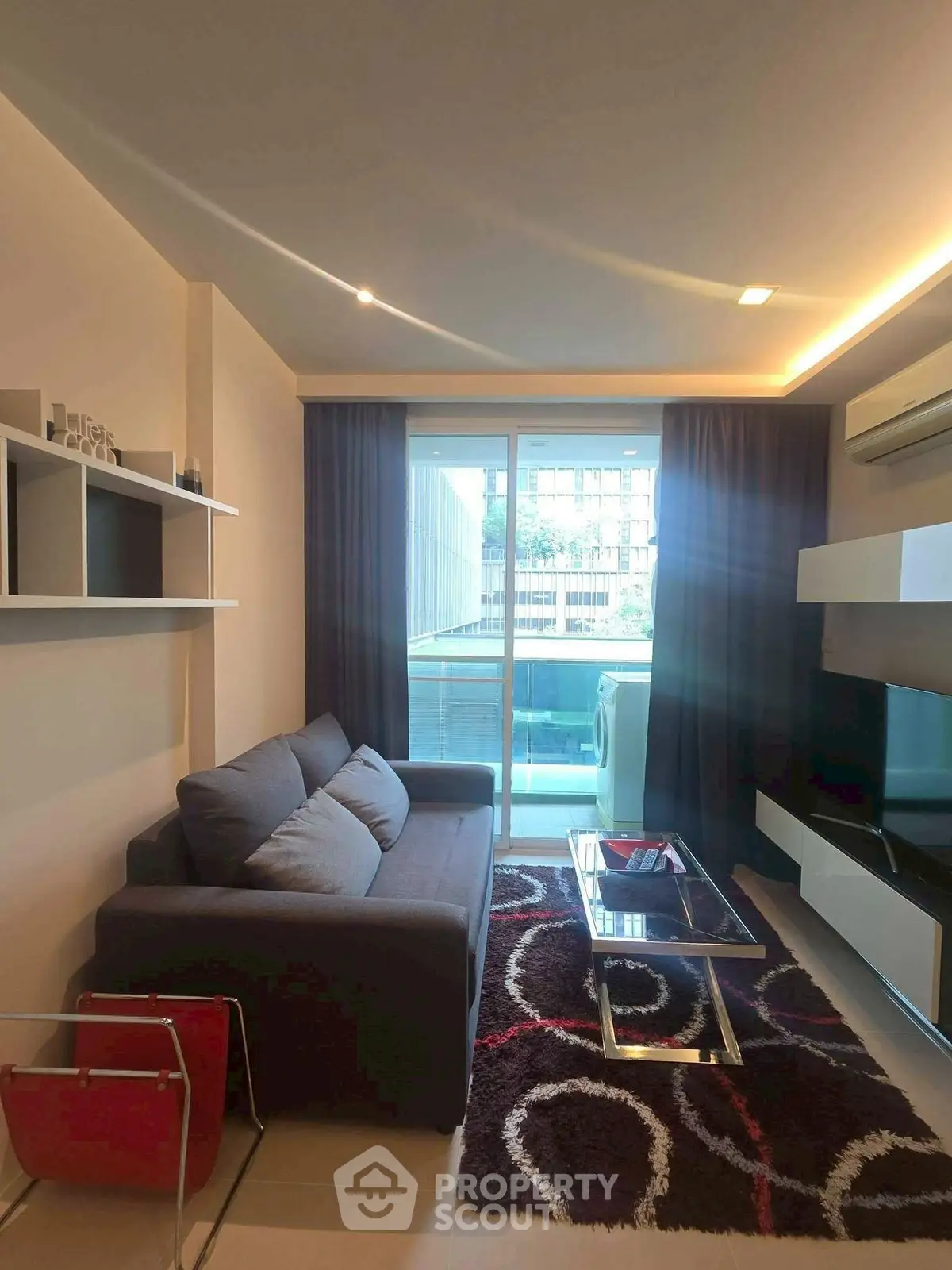 Modern living room with sleek furniture and balcony view