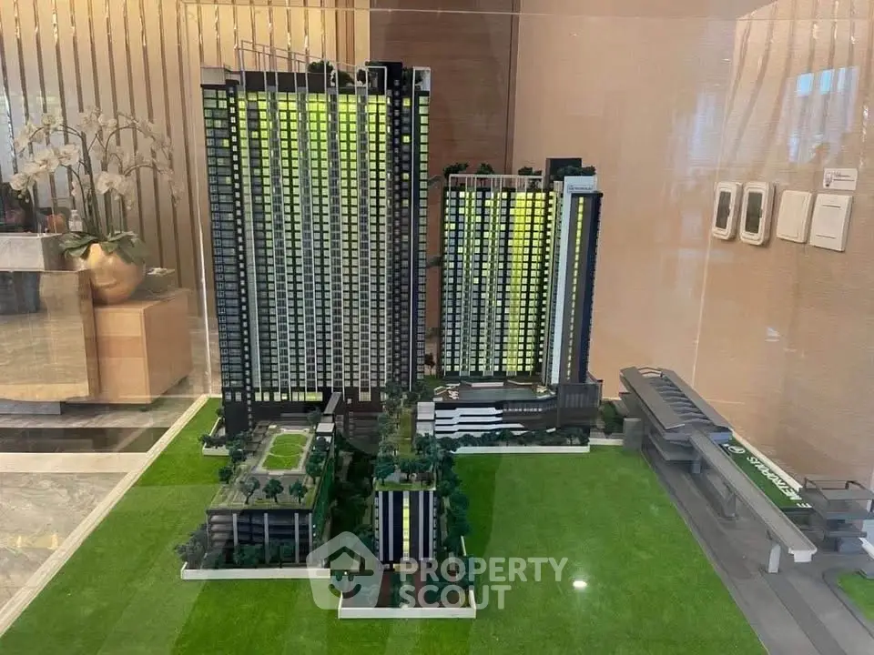 Stunning architectural model of modern high-rise residential complex with lush green surroundings.