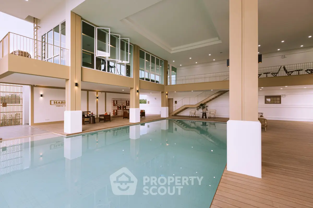 Luxurious indoor pool area with modern design and ample natural light, perfect for relaxation and leisure.