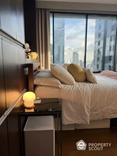 Luxurious bedroom with city view, modern decor, and plush bedding in high-rise apartment