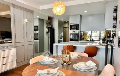 Modern kitchen with stylish dining area and elegant lighting