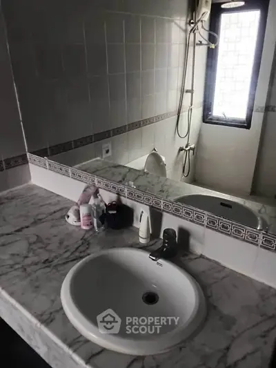 Elegant bathroom with marble countertop and modern fixtures, perfect for a stylish home.