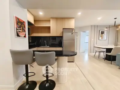 Modern open kitchen with sleek design and stylish bar stools