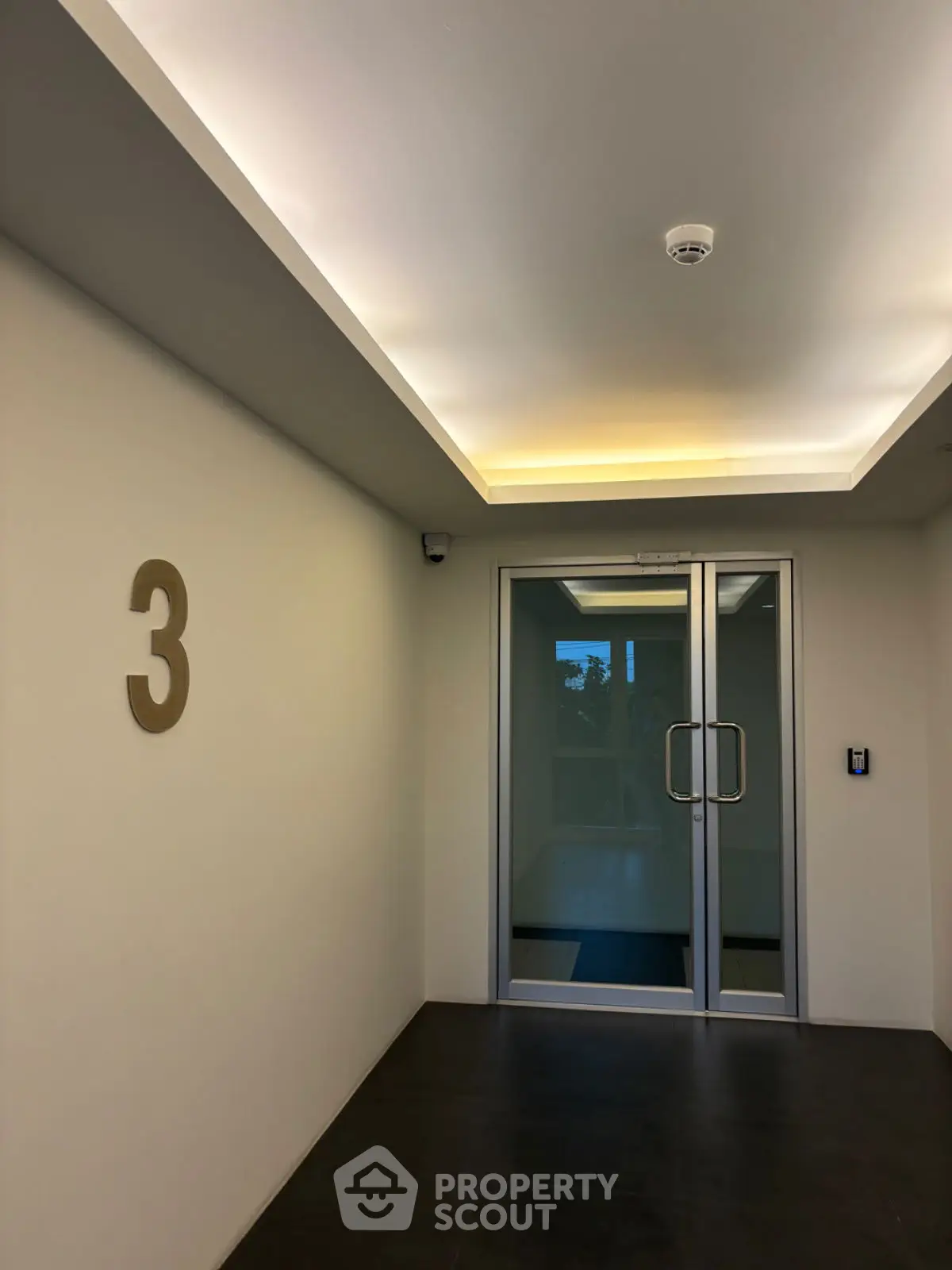Modern building entrance with sleek design and ambient lighting
