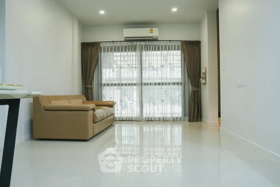 Spacious living room with modern sofa and large windows for natural light