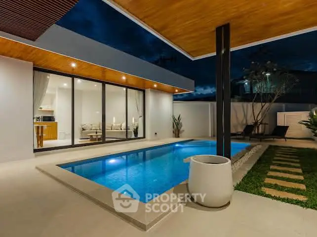 Luxurious modern villa with private pool and elegant outdoor lighting, perfect for serene evenings.