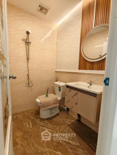 Modern bathroom with elegant tile flooring and stylish fixtures.