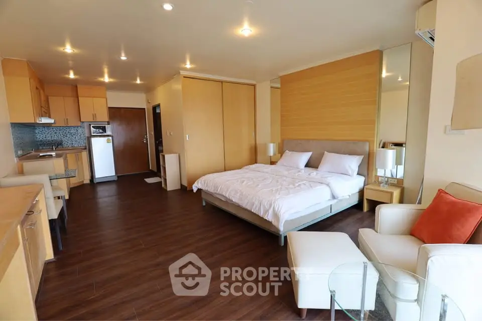 Spacious studio apartment with modern kitchen and cozy living area, perfect for urban living.