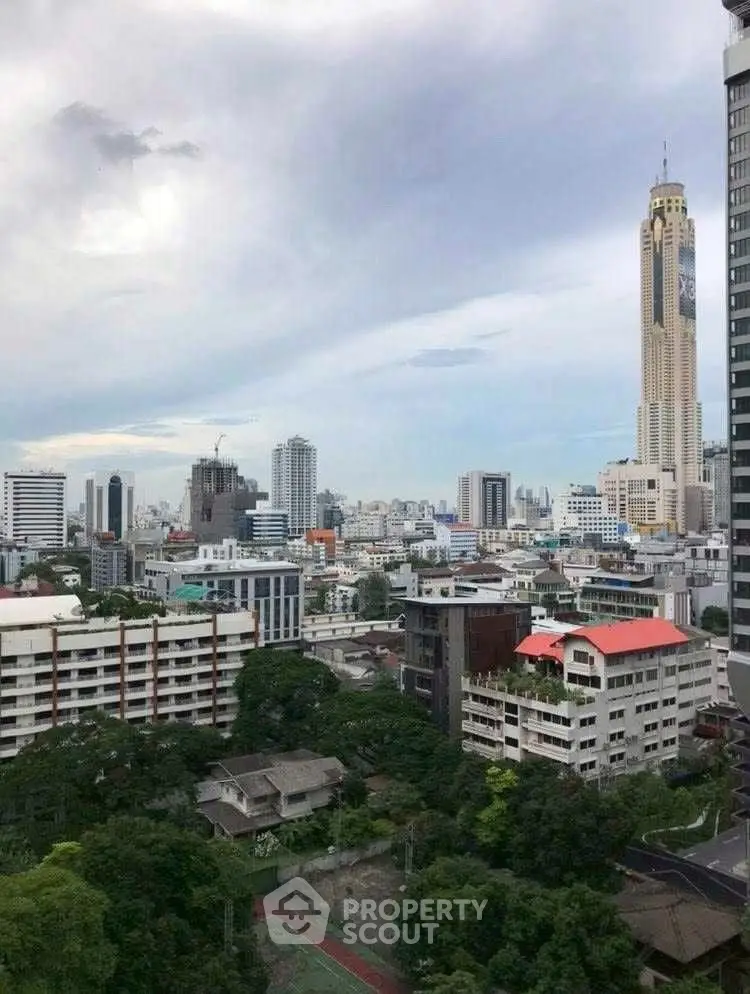 Stunning cityscape view showcasing a vibrant urban skyline with lush greenery and high-rise buildings.