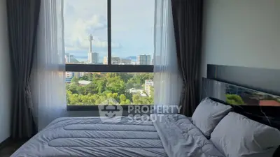 Luxurious bedroom with stunning city view and elegant decor.