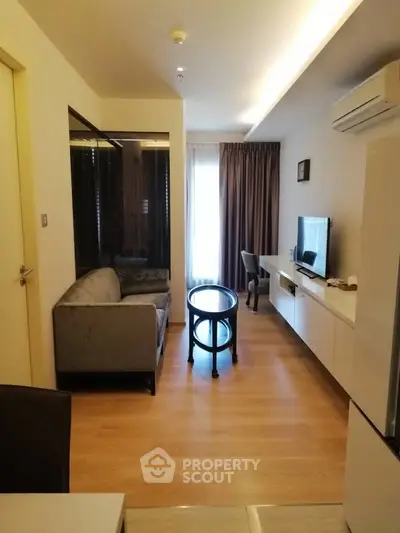 Modern living room with sleek furniture and natural light, perfect for relaxation and entertainment.