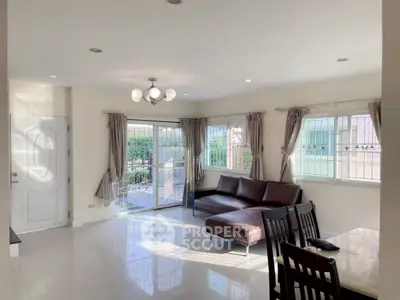 Spacious living room with modern furniture and large windows for natural light.