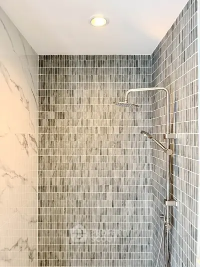 Modern bathroom shower with elegant tile design and rainfall showerhead