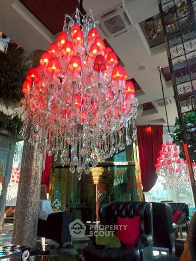 Luxurious living room with stunning red chandelier and elegant decor