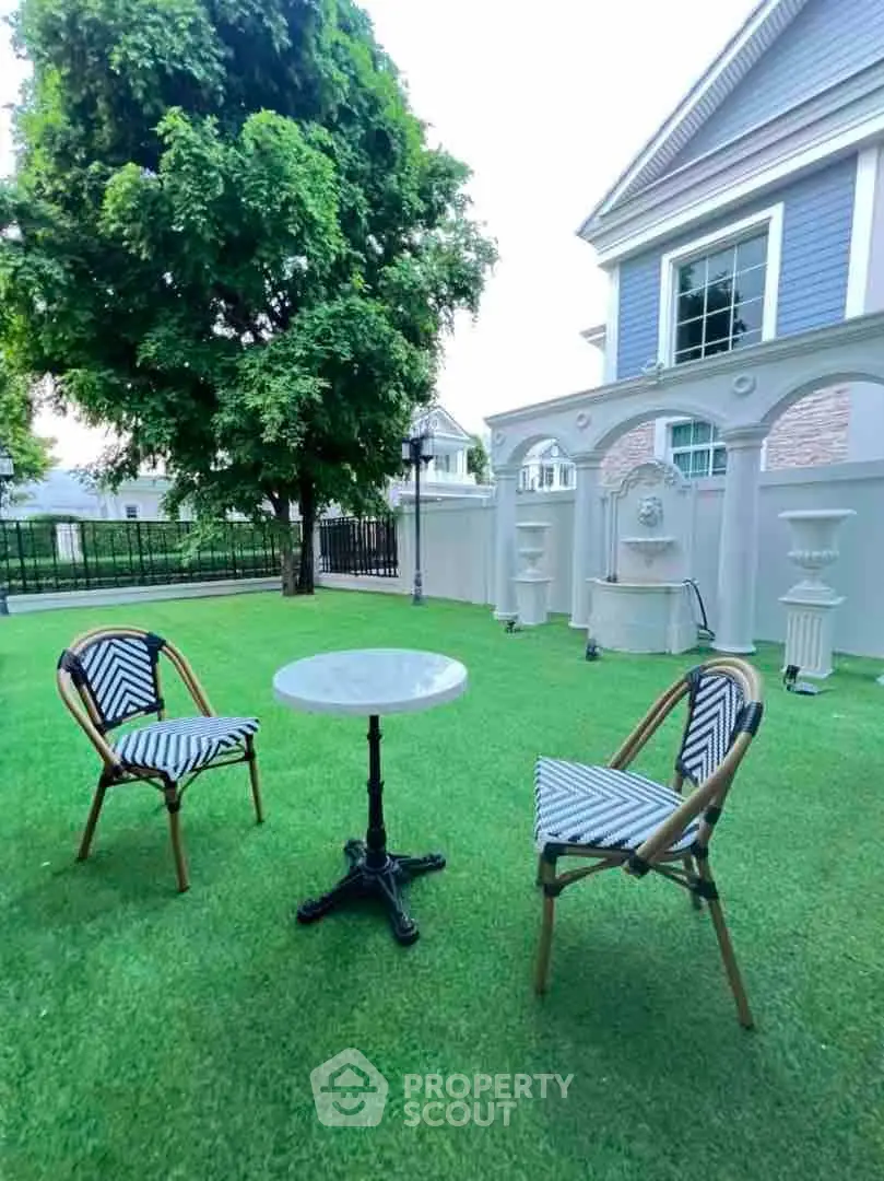 Charming garden with elegant outdoor seating and lush greenery