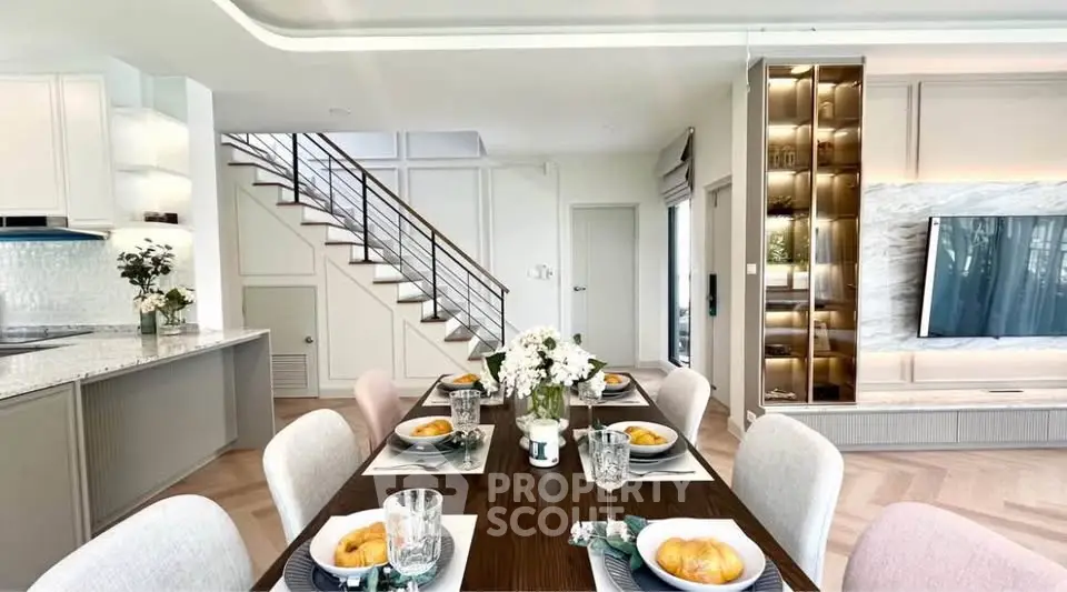 Elegant open-plan living and dining area with modern kitchen and stylish decor