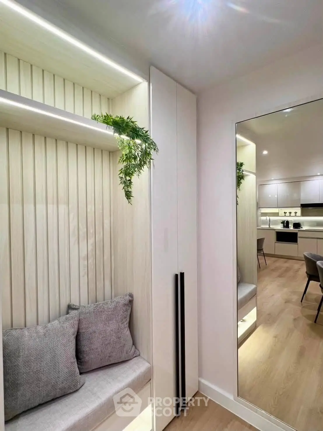 Modern interior with cozy seating nook and sleek kitchen design