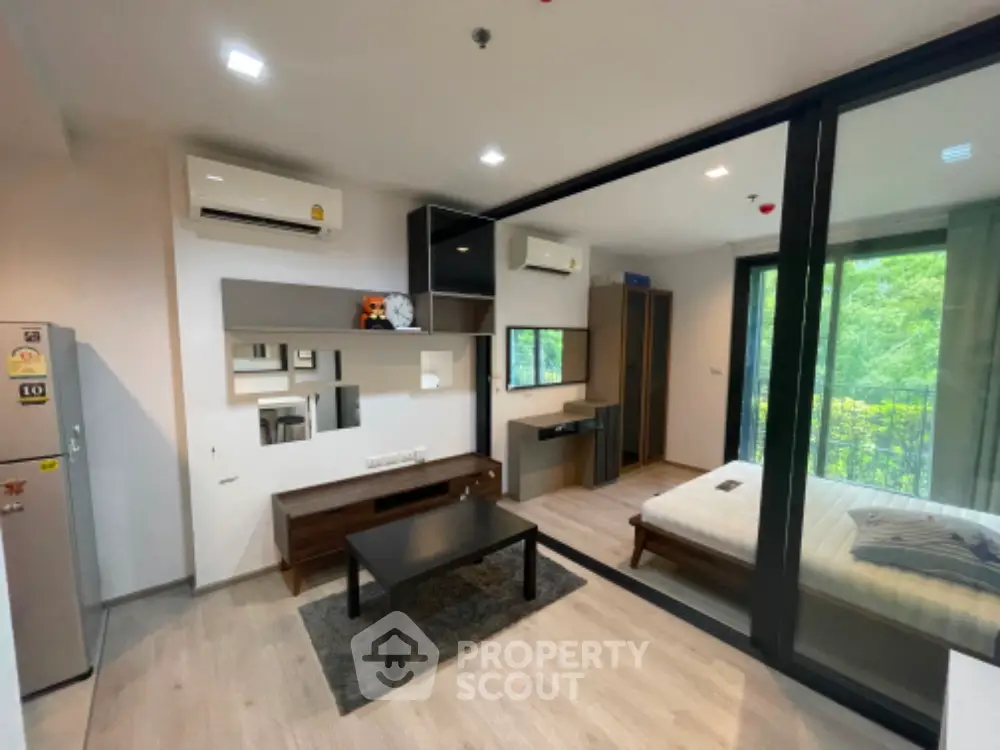 Modern studio apartment with open layout and balcony view