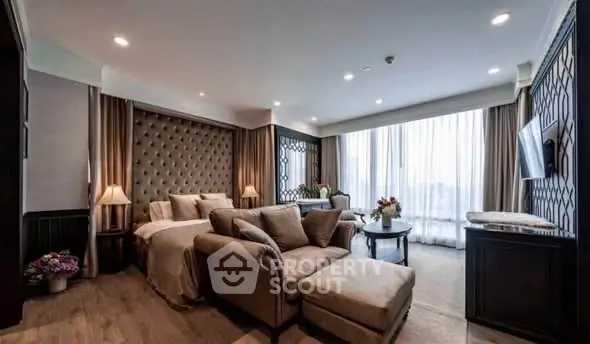 Luxurious living room with elegant decor and large windows offering natural light.