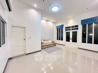 Spacious modern living room with high ceilings and elegant lighting