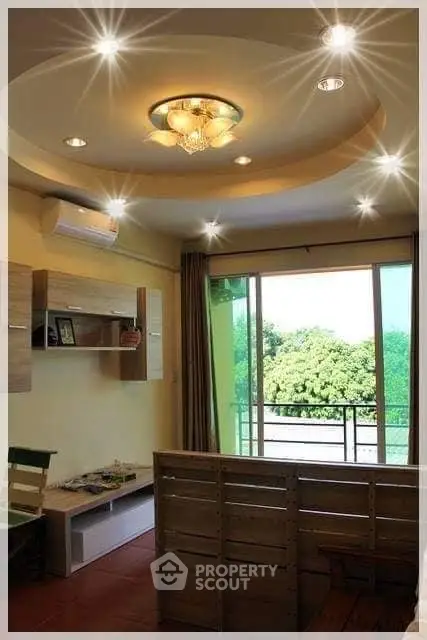 Charming living room with modern lighting and balcony view