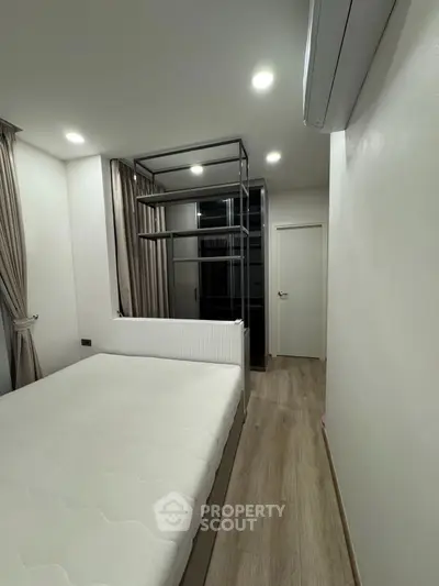 Modern minimalist bedroom with sleek design and ample natural light