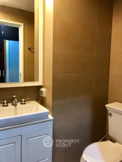 Modern bathroom with sleek fixtures and neutral tile design