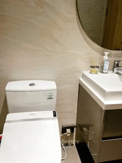 Modern bathroom with sleek fixtures and round mirror