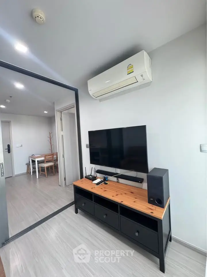 Modern living room with sleek air conditioning and stylish TV setup
