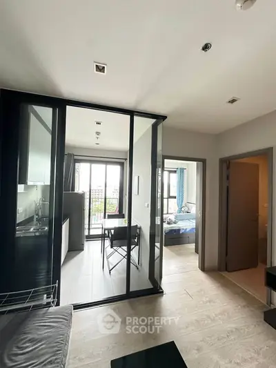 Modern apartment interior with open layout, featuring a cozy living area and a stylish kitchen.