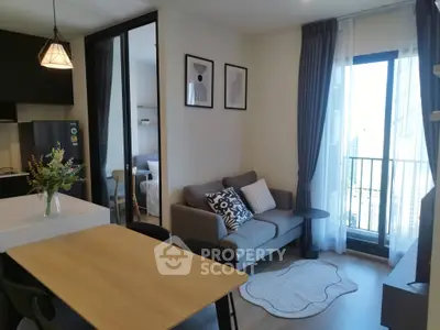 Modern living room with stylish decor and balcony view in a contemporary apartment.