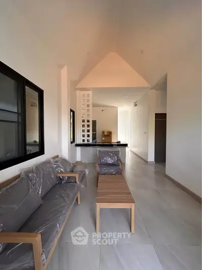 Spacious modern living room with high ceiling and elegant furniture