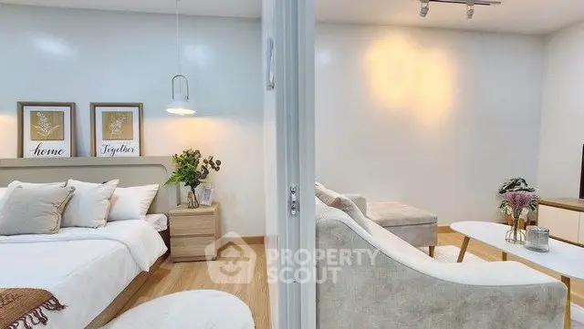 Modern open-concept bedroom and living room with stylish decor and cozy ambiance.