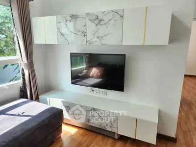Modern living room with stylish marble TV cabinet and natural light